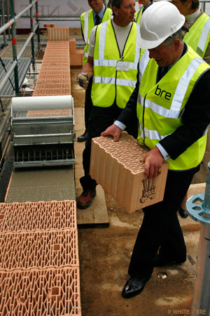 Prince Charles carries a monogrammed block which he placed into the wall (Photo: Peter White, BRE)